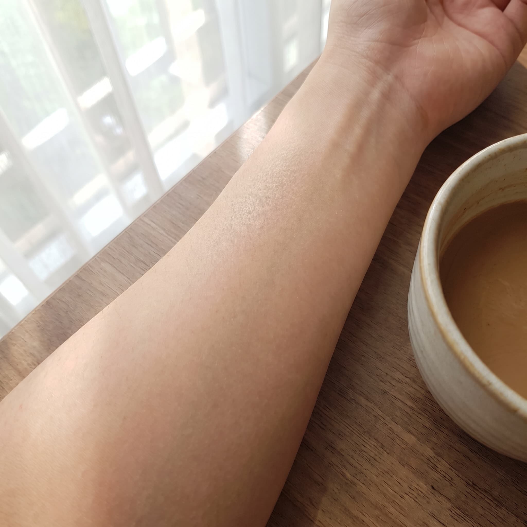 An arm, before and after a tattoo placement preview — before
